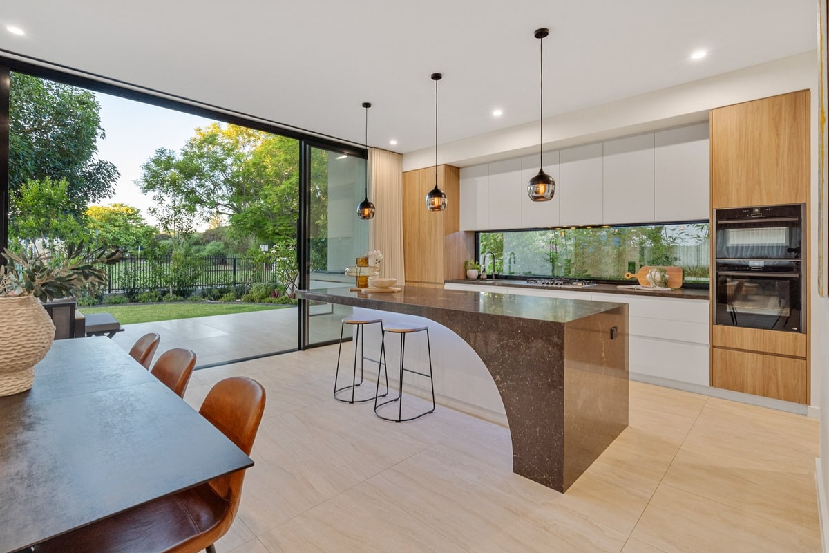 Open-plan kitchen with large glazing opening to garden, Floreat